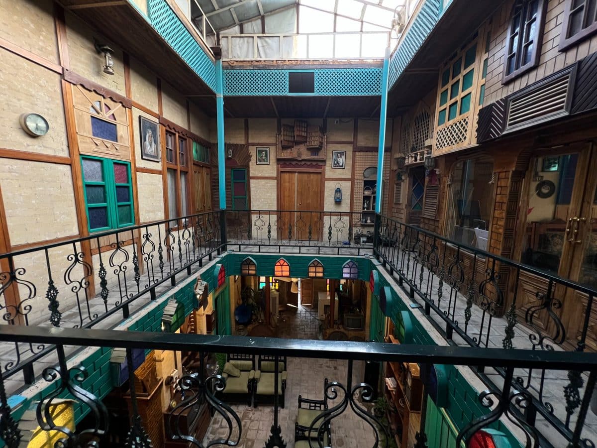 Upper floor view of Ali Babylon Tours Baghdad guesthouse courtyard with traditional Iraqi architecture