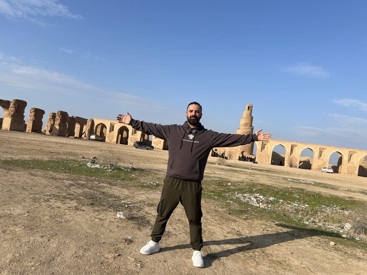 Ali with arms outstretched at the ruins of the Great Mosque of Samarra Iraq