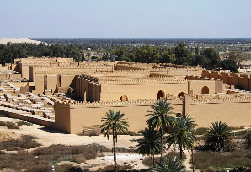 Aerial view of ancient Babylon ruins with palm trees and city walls, Iraq