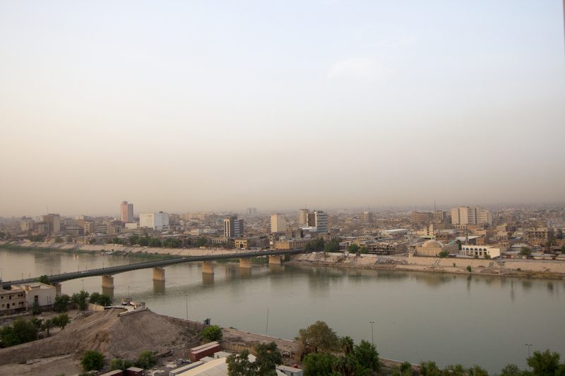 Aerial view of Baghdad with a bridge spanning the Tigris River at dusk, Iraq