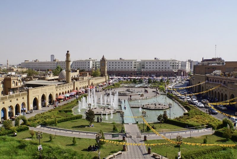 Aerial view of Erbil citadel square with fountains, park and surrounding buildings, Kurdistan Iraq