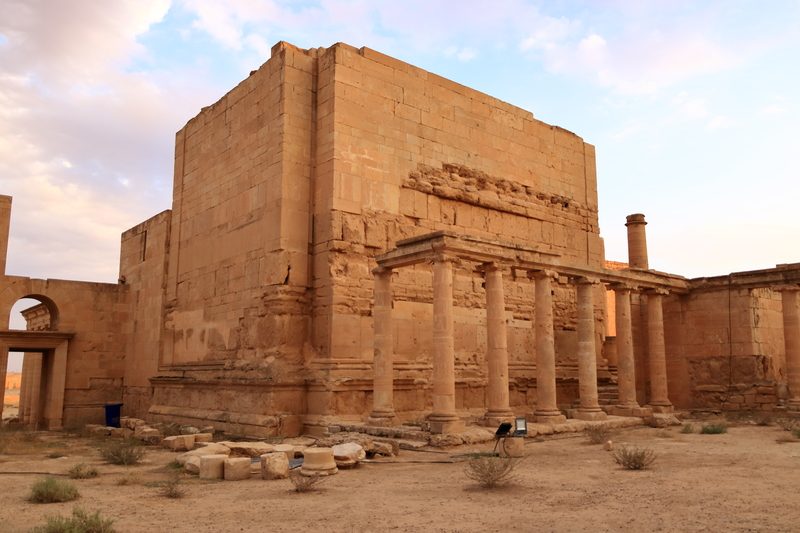 Stone temple with ancient columns at the ruins of Hatra at sunset, Iraq
