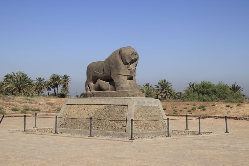 The ancient Lion of Babylon basalt statue on its stone pedestal at the Babylon archaeological site, Iraq